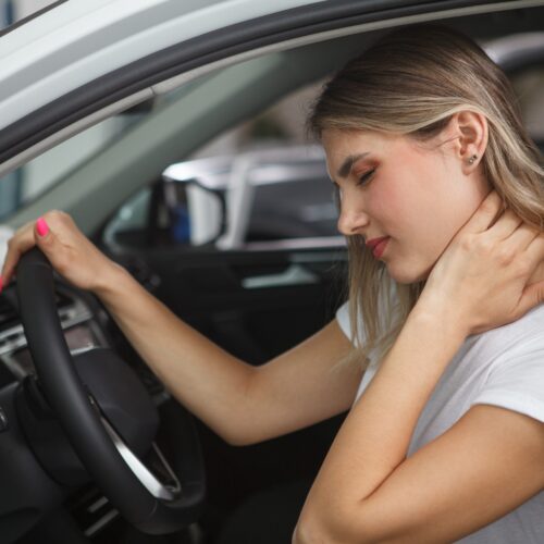 Young woman suffering from neck whiplash