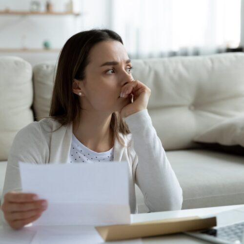 Worried woman reviewing medical bills
