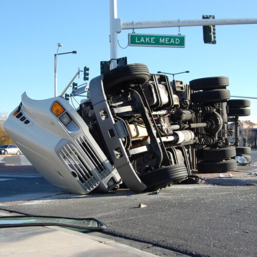 Semi-truck flipped on its side after a trucking accident