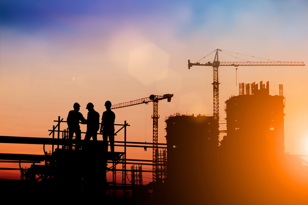 Silhouette of engineer and construction team working at site over blurred background for industry background with Light fair. Create from multiple reference images together