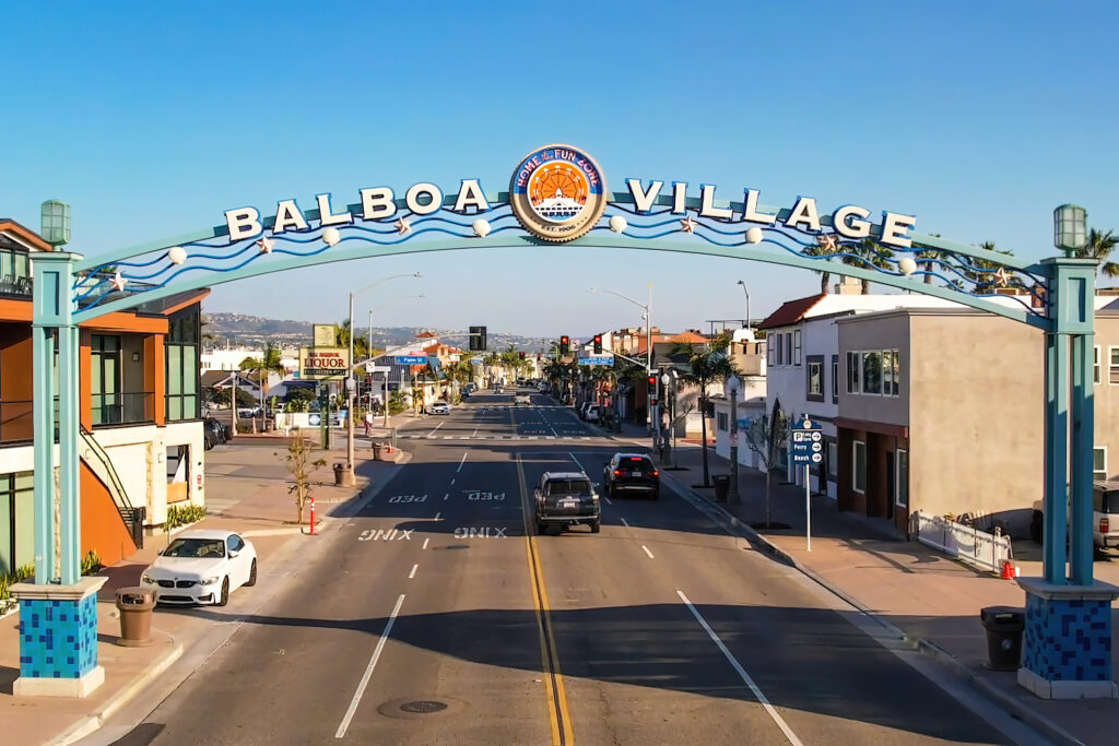 An overhead sign posted in Newport Beach California welcoming all to Balboa Village