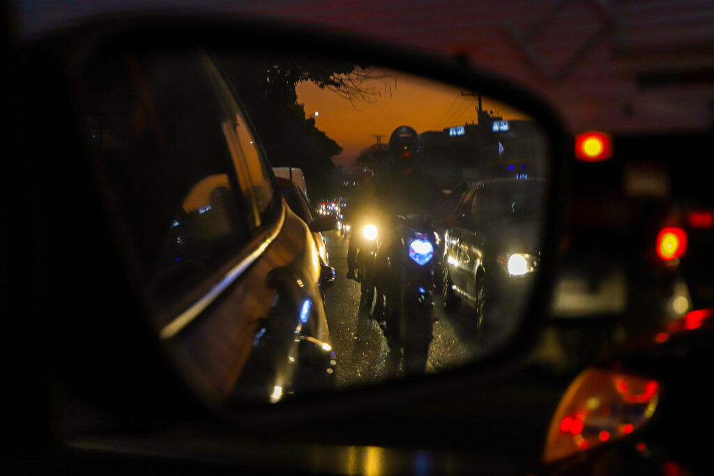 Rear-view mirror of oncoming motorcyclist about who could suffer an accident from dooring 