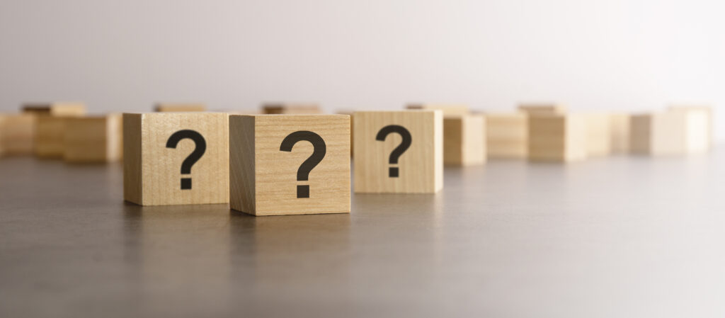 wooden blocks with question marks printed on them to symbolize common questions 
